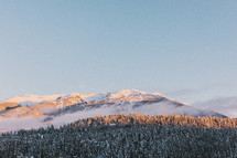 Clouds on a snow-covered mountain range.