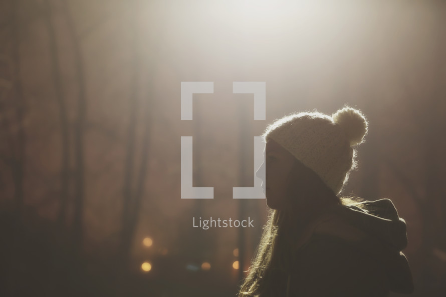 woman, standing, outdoors, side profile, wool cap, night 