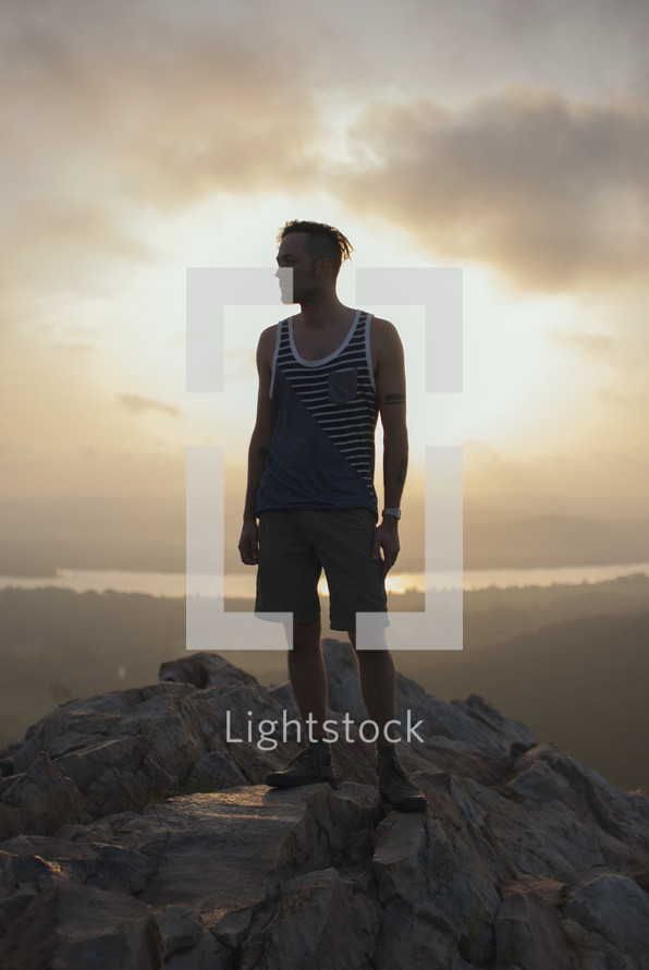 man standing on top of a mountain 