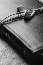 ear buds wrapped around a Bible