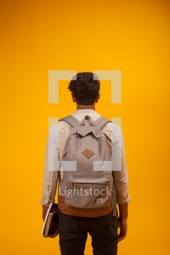 a man with a backpack and books 