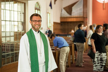 priest standing in a church 