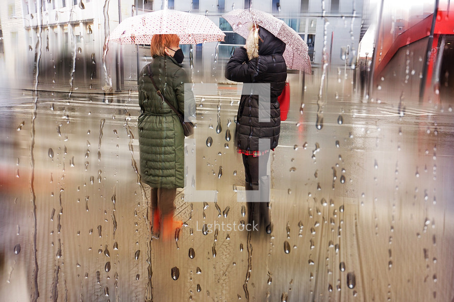 people with an umbrella in rainy days in Bilbao city, basque country. Spain