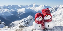 Snowman family on the top of the mountain in winter season.