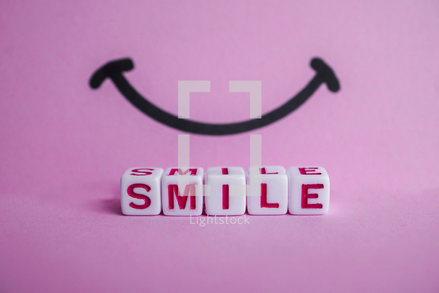smile word on the pink background, feelings and emotions