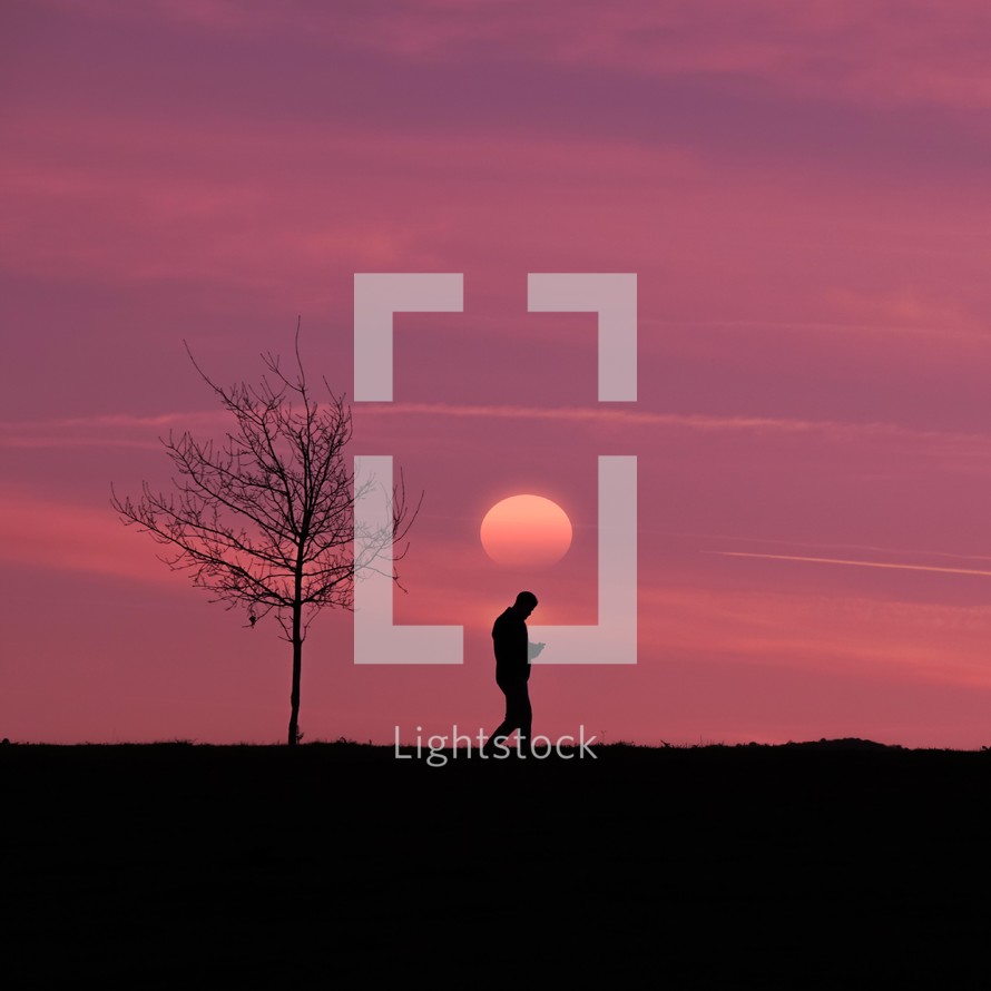 man walking in the countryside and sunset background