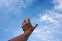 hand up in the air, blue sky background