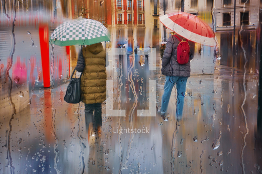 people with an umbrella in rainy days in Bilbao city, spain