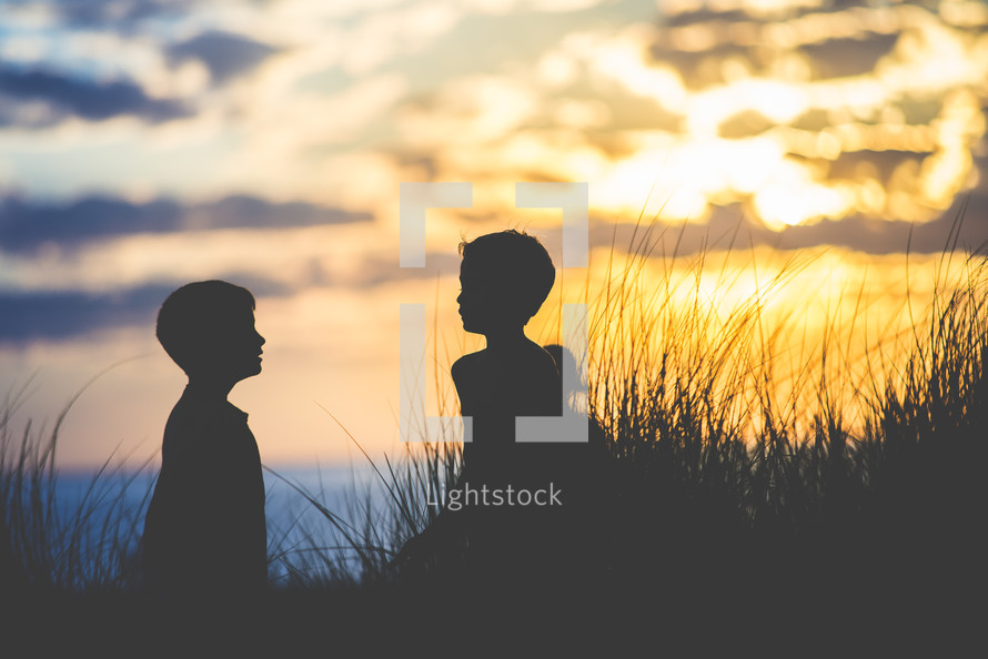silhouettes of children on a beach 