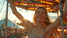 Happy young woman having fun on a carousel at sunset