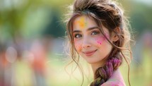 Portrait of a beautiful young woman with colorful powder paint on her face