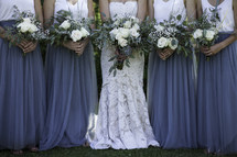 bridesmaids and bride holding bouquets at a wedding 