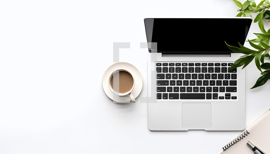 Top view of modern workplace with laptop, coffee cup and notebook on white background