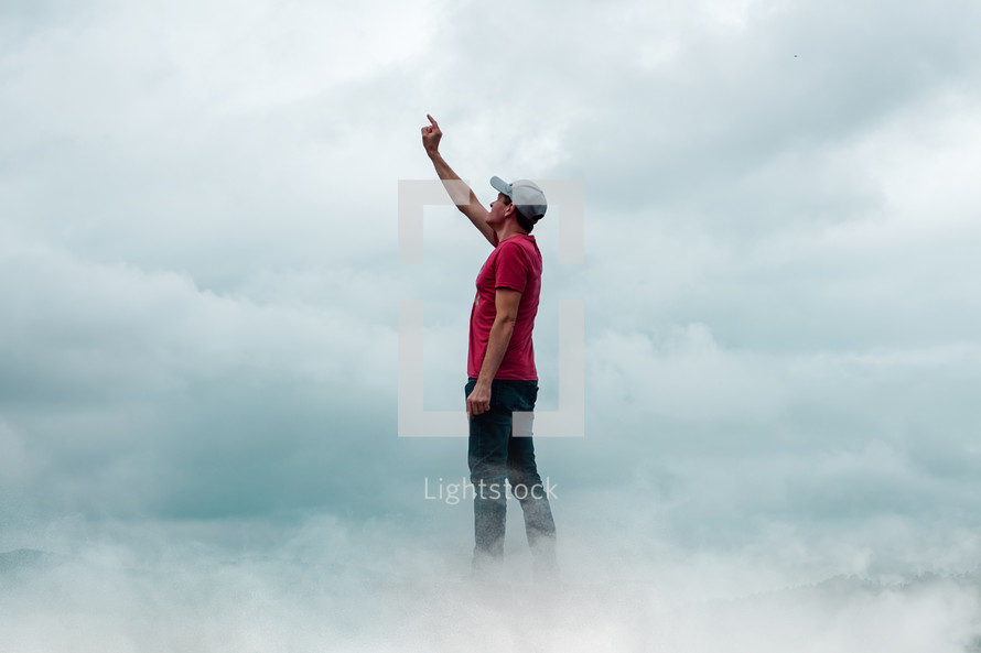 man praying among the clouds