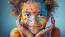 Portrait of a beautiful little girl with paint on her face.