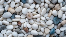White and blue pebble stones background. Top view, flat lay.