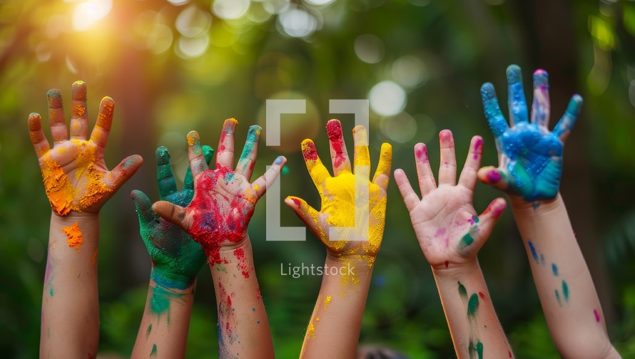 Hands of child covered with colorful paint on holi festival.
