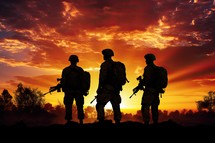 Silhouette of soldiers on a sunset background. Concept of war.