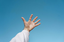 man hand up gesturing in  the blue sky, feelings and emotions