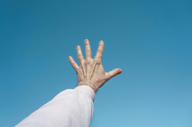 man hand up gesturing in  the blue sky, feelings and emotions