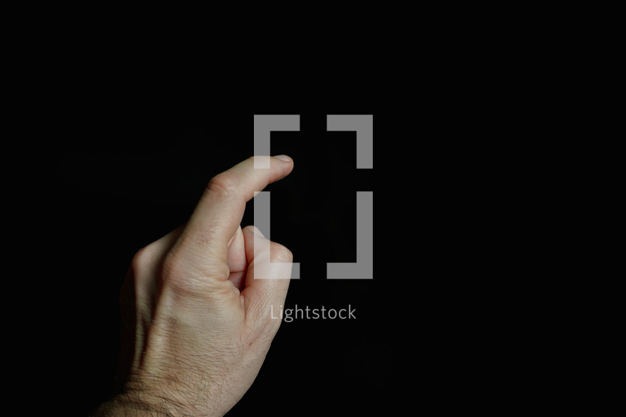 index finger pointing at a digital screen