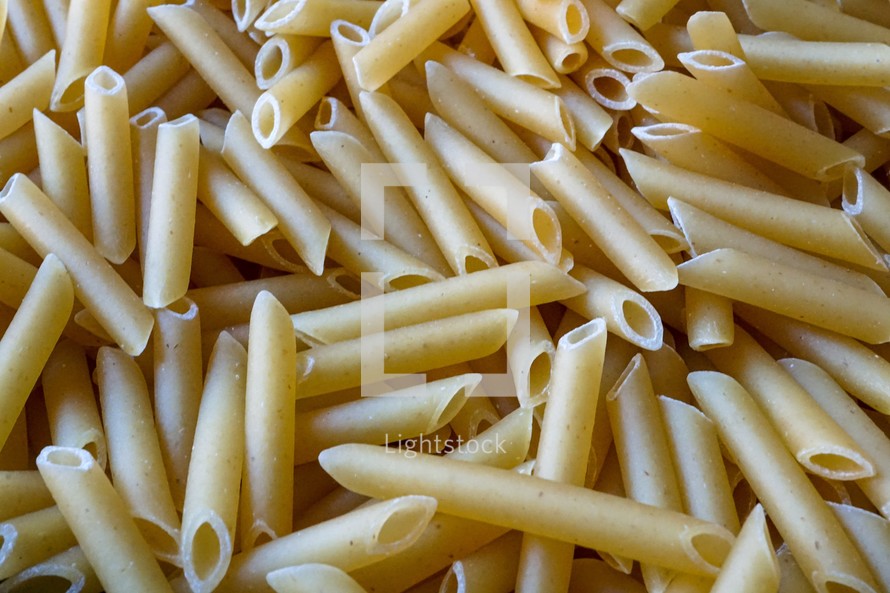 raw macaroni pasta background, italian food