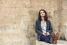 teen girl sitting on concrete  steps 