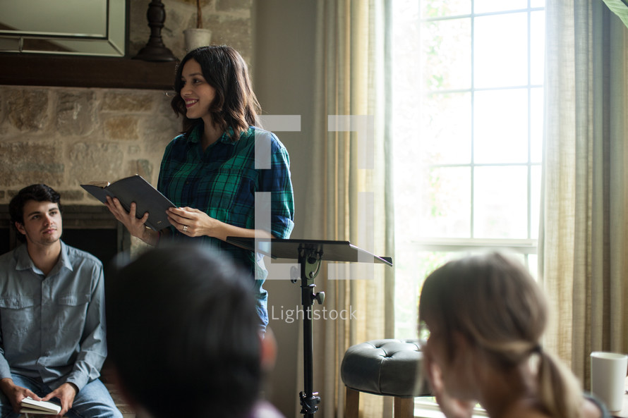 A young woman leads a home Bible study.