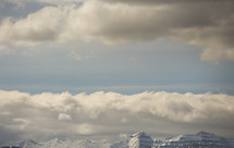 snow covered mountain peaks with sky and clouds and copyspace