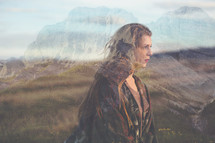 double exposure of rugged mountains and young woman