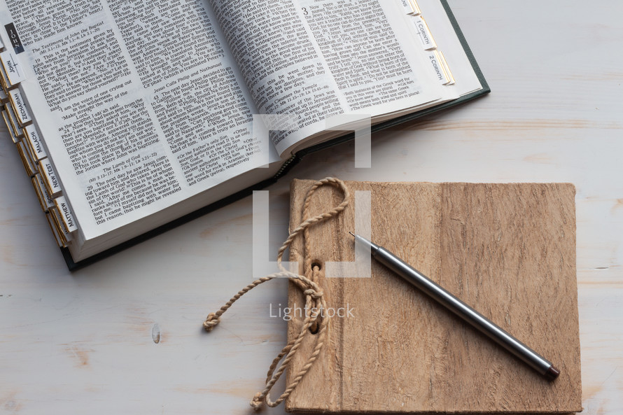 Bible and journal on a white wood background 