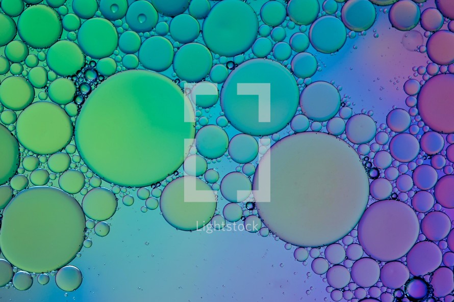 colorful oil circles on the water, abstract background