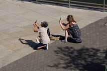 tourist taking photos with the phone in Bilbao city, spain, phone addicted