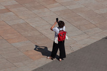tourist taking photos with the phone in Bilbao city, spain, phone addicted