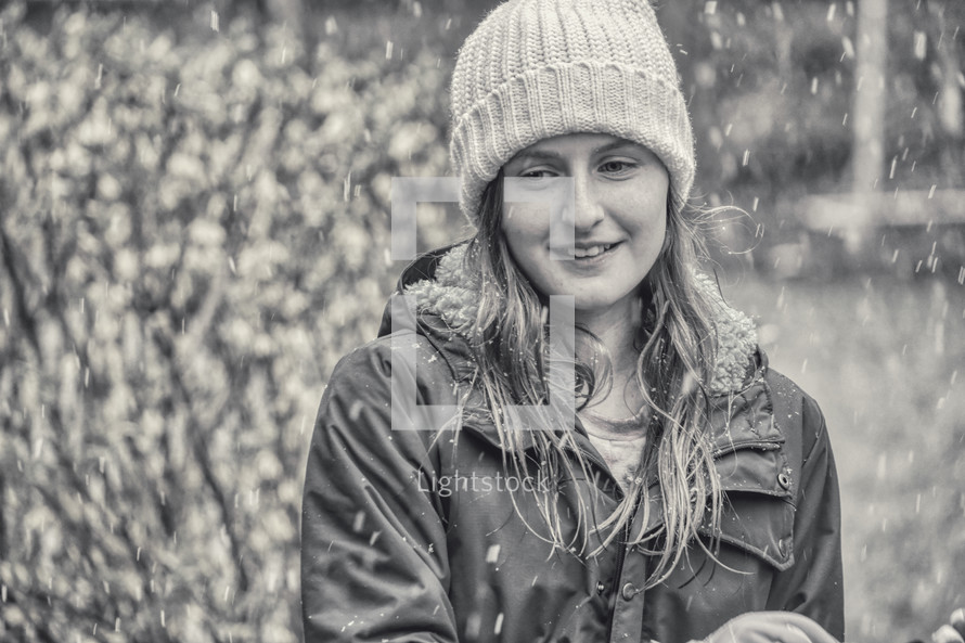 a girl in falling snow 