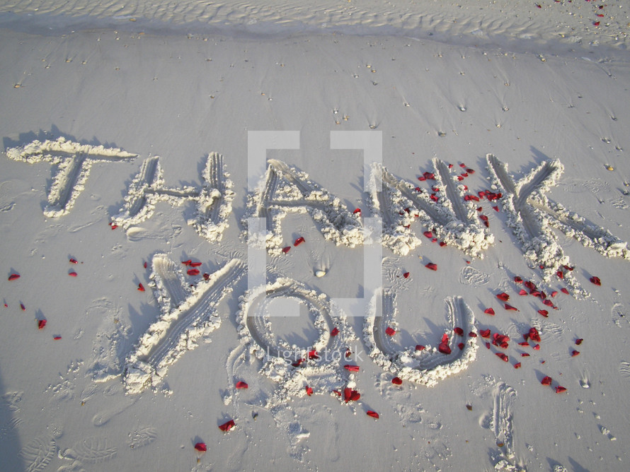 Thank you written in the sand 