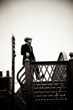 man in a hat walking up stairs 