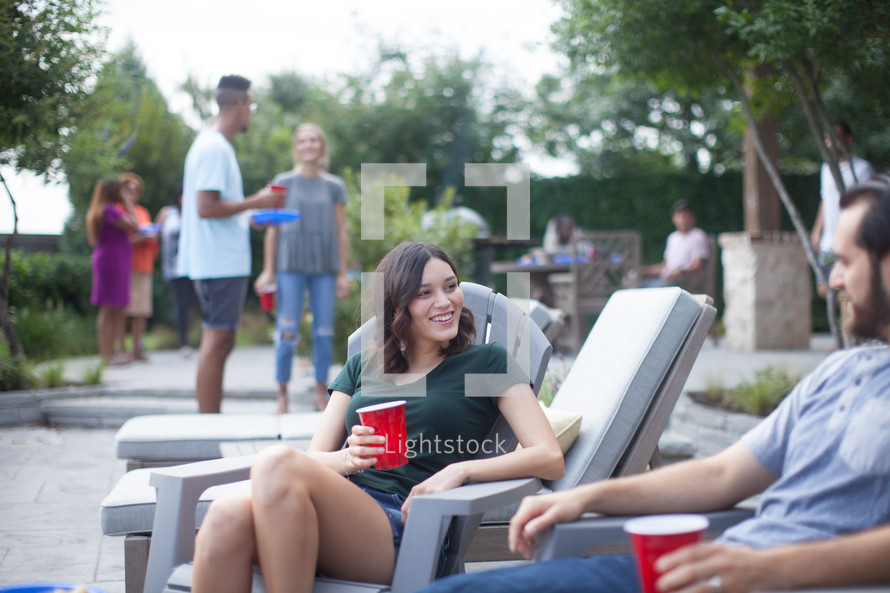 friends talking at a backyard summer party
