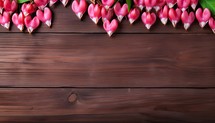 Valentine's Day background with pink flower on wooden table