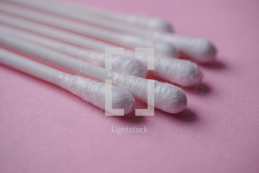 cotton swabs on the pink background