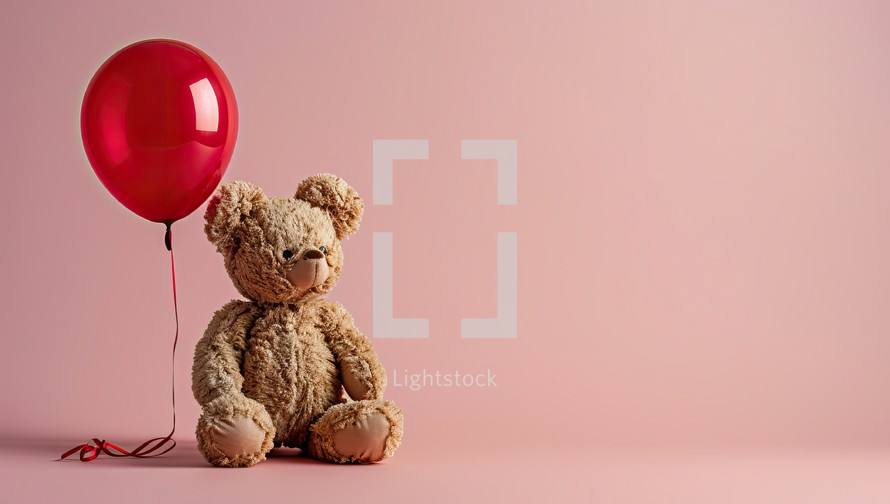 Teddy bear with red balloon on pink background