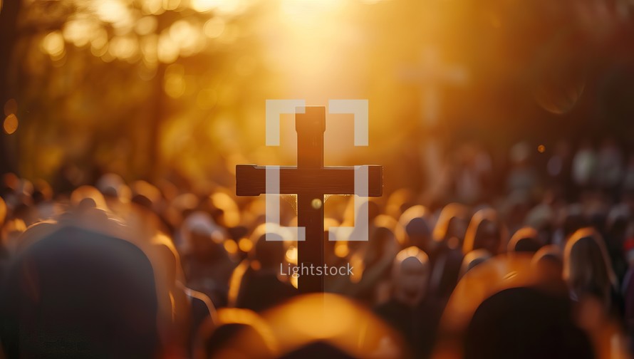 Crowd gathering around a cross in the golden hour
