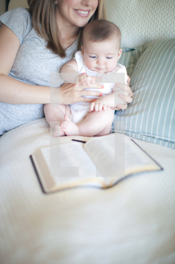 mother and baby and an open Bible