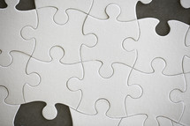 a puzzle with missing pieces 