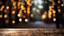 Wooden table in front of blurred christmas tree with bokeh lights