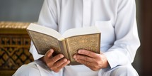 Muslim man reading holy quran in mosque, Ramadan Kareem concept