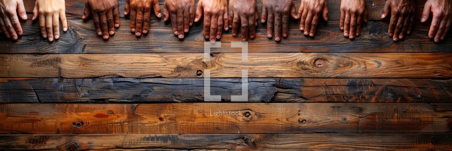 Unity diversity teamwork concept with diverse hands on rustic wooden table