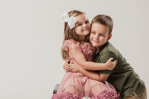 portrait of brother and sister hugging 