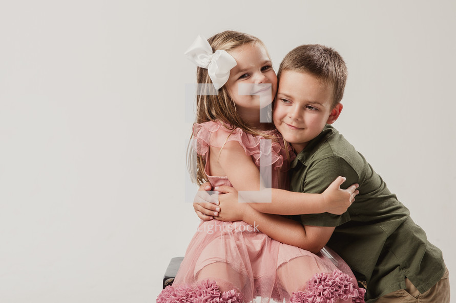 portrait of brother and sister hugging 