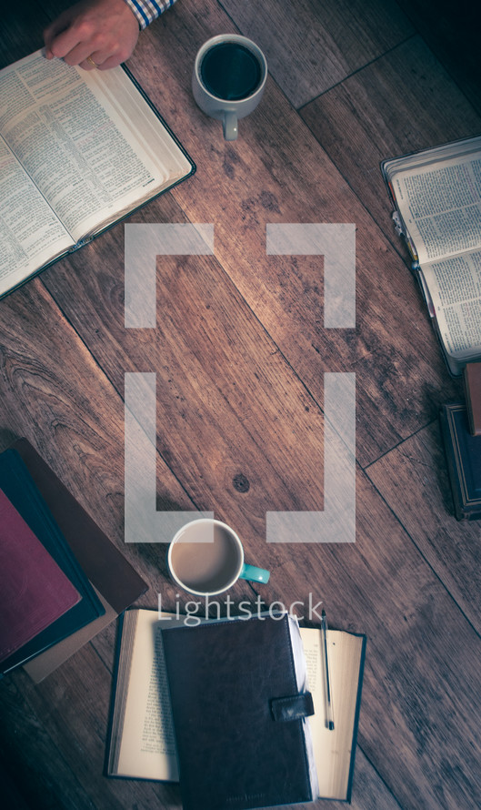 Bible study, notebooks, and coffee cups.